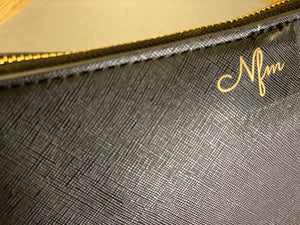 close-up-nfm-logo-in-gold-on-black-leather-bag