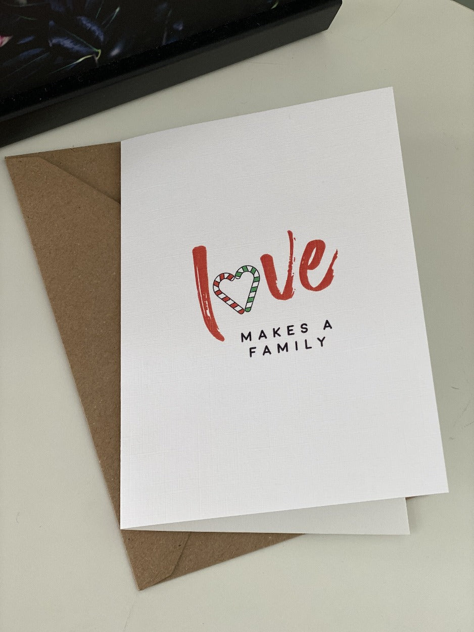 love-makes-a-family-fist-christmas-card-candy-cane-biodegradable-packaging