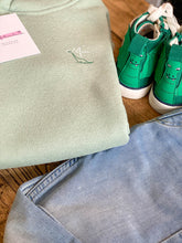 Load image into Gallery viewer, green-kids-hoodie-dino-nfm-logo-next-to-green-kids-dino-trainers-from-the-adoption-gift-range-by-notafictionalmum
