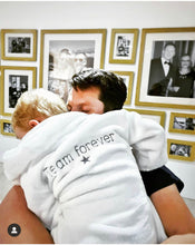 Load image into Gallery viewer, boy-wearing-team-forever-white-dressing-gown-hugging-father
